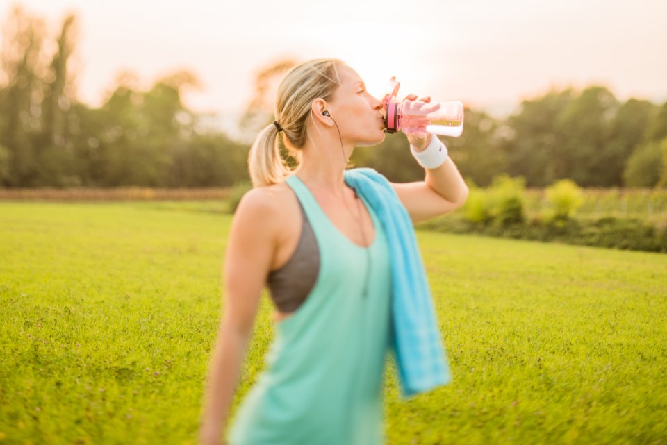 Woman staying hydrated during outdoor exercise